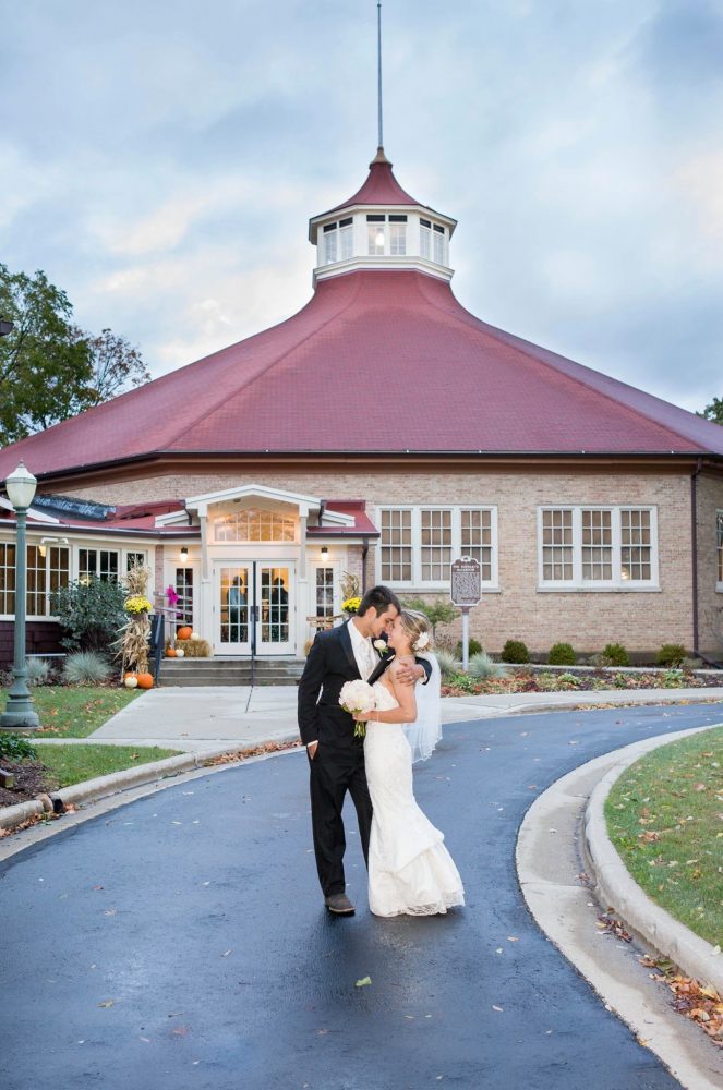 Bride and groom kiss outside the Chandelier Ballroom in Hartford, WI
