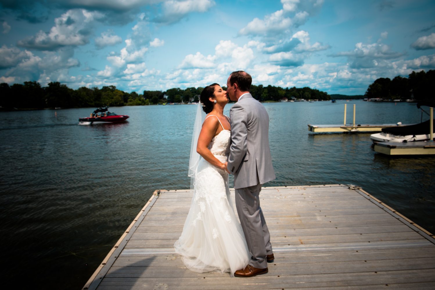 Wedding couple kissing on pier at Golden Mast