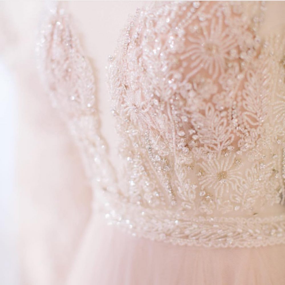 detail of soft pink wedding gown