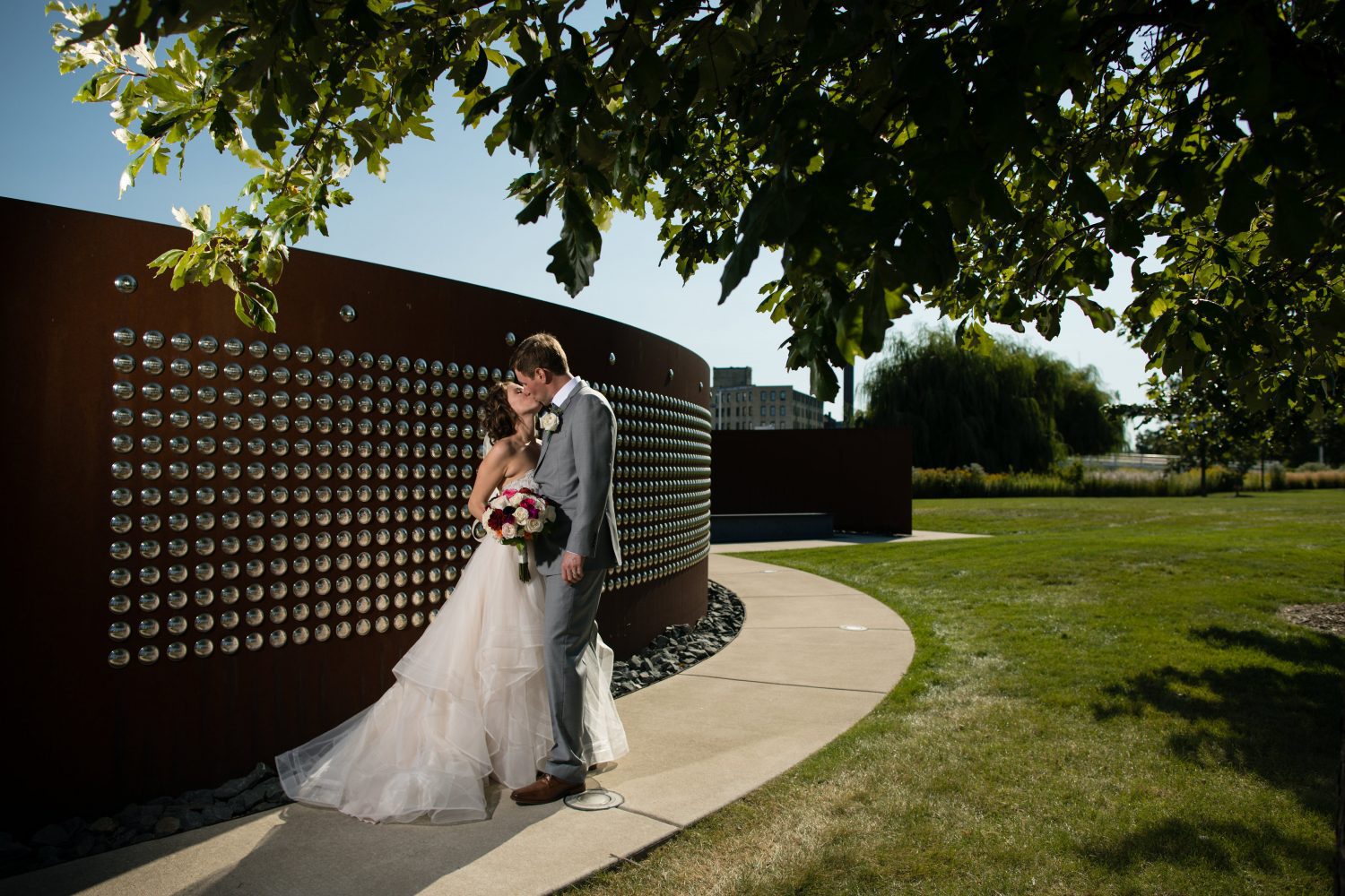 Bride and groom kiss outside 1903 Events at the Harley Davidson Museum