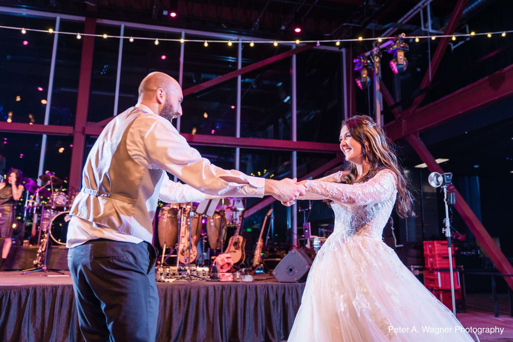 Claire and Nick celebrate their first dance in the warmly lit reception hall of Jan Serr Studio.