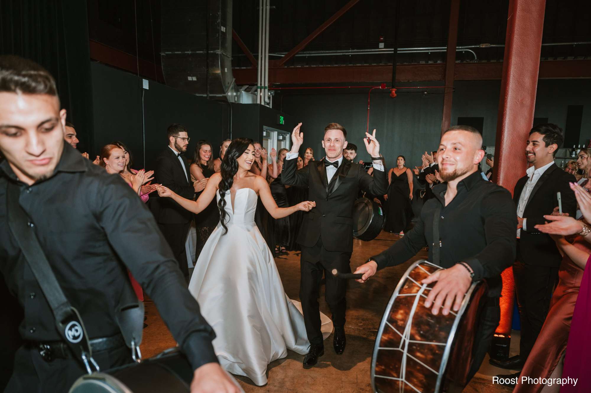 Leila and Nick share a romantic embrace against the industrial backdrop of Jan Serr Studio.