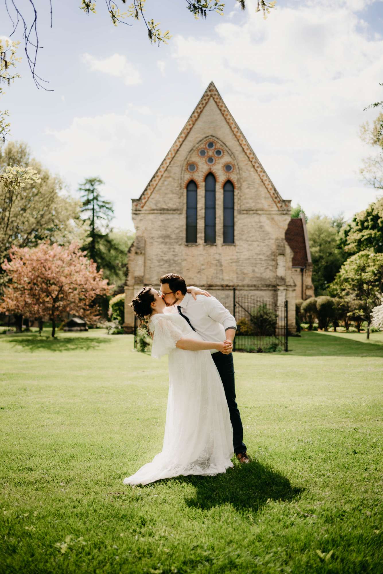 Groom kisses bride outside of the chapel at the Dekoven Center in Racine, WI