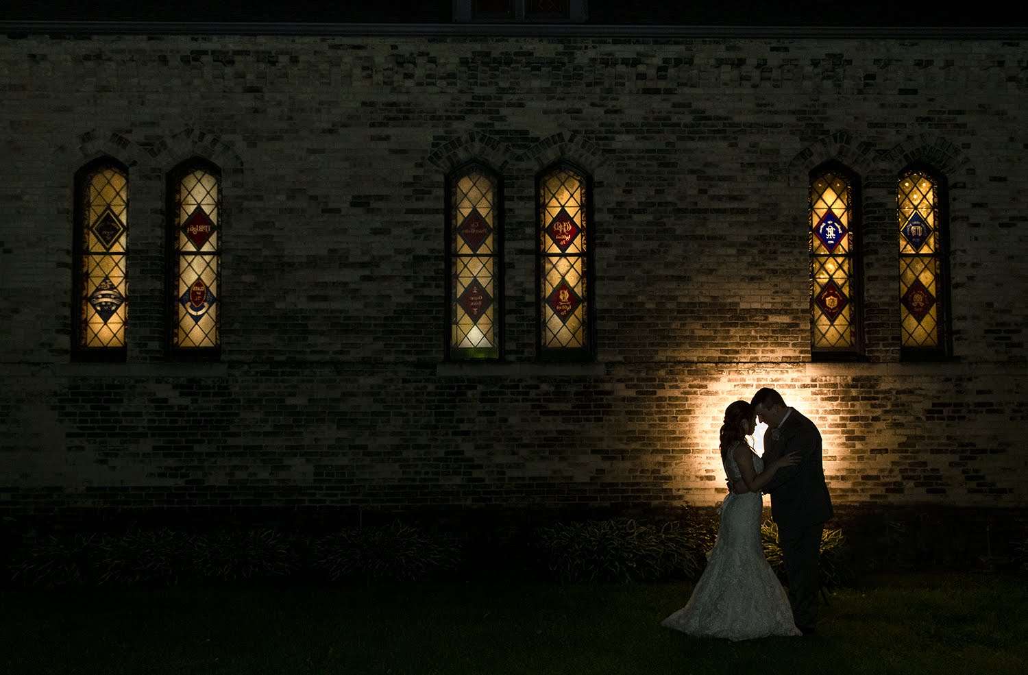 Bride and groom silhouette outside of chapel at Dekoven Center