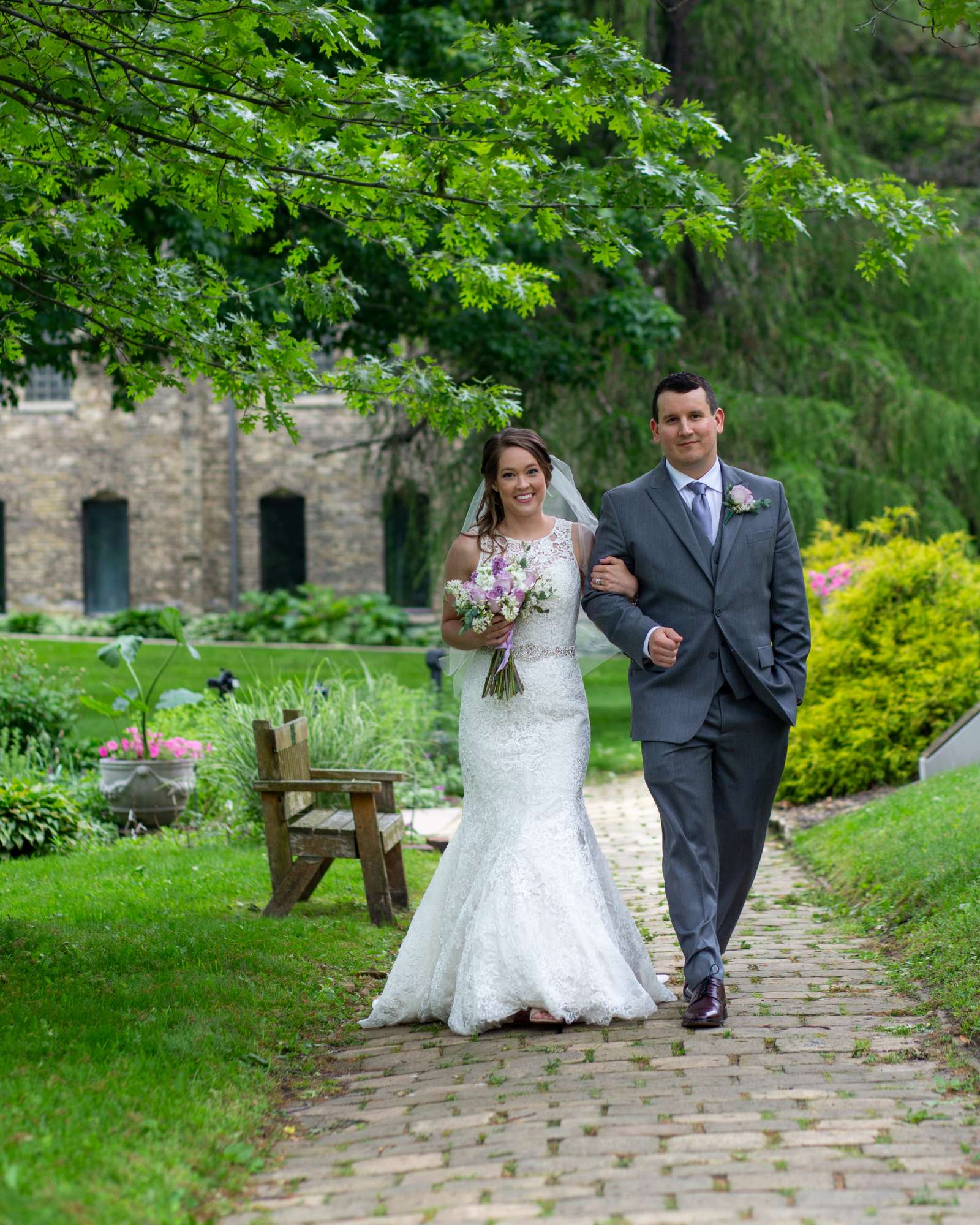 Wedding couple strill arm in arm down path at Dekoven Center