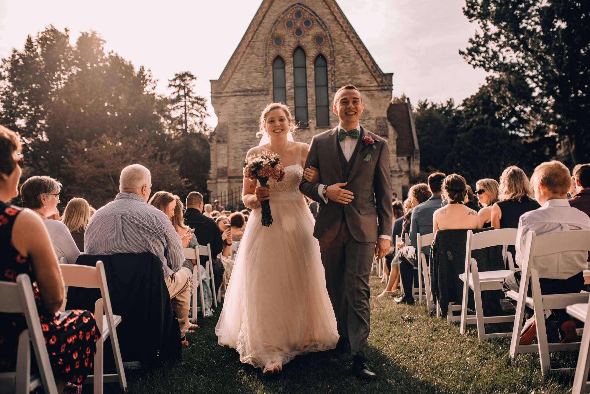 Bride and groom come back up the aisle at outdoor wedding ceremony
