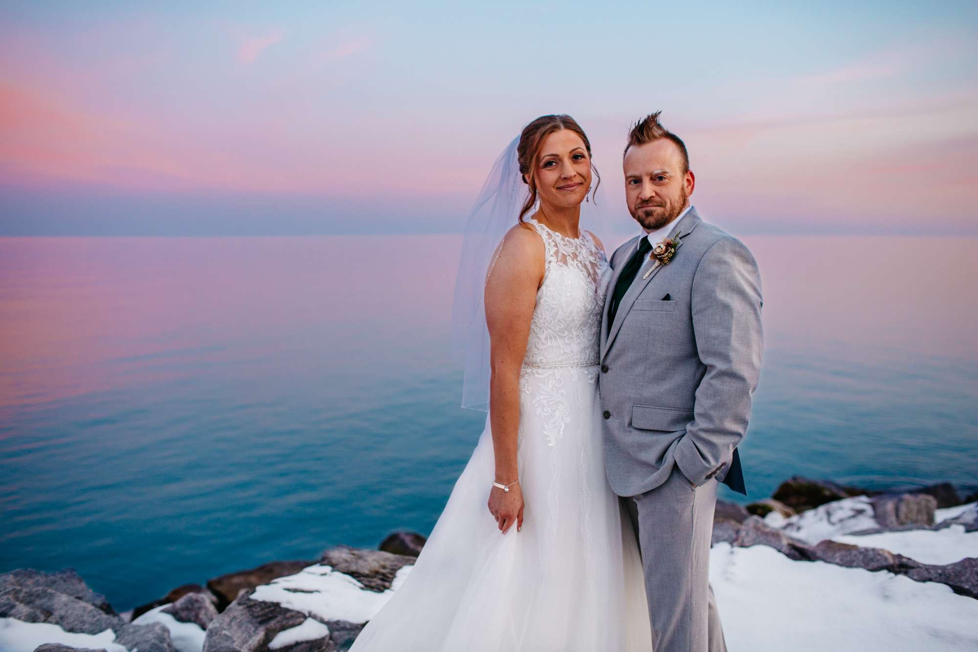 Bride and groom pose near Lake Michigan