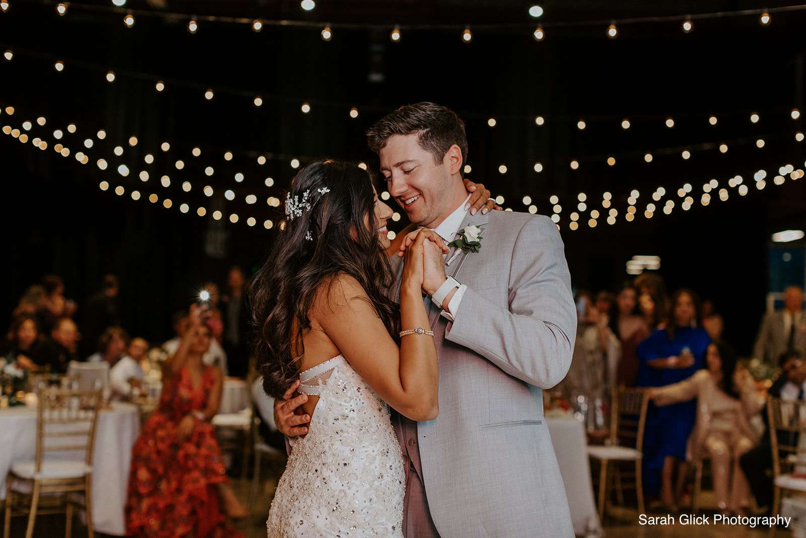 The newlyweds share a heartfelt kiss during their wedding reception at Jan Serr Studio.