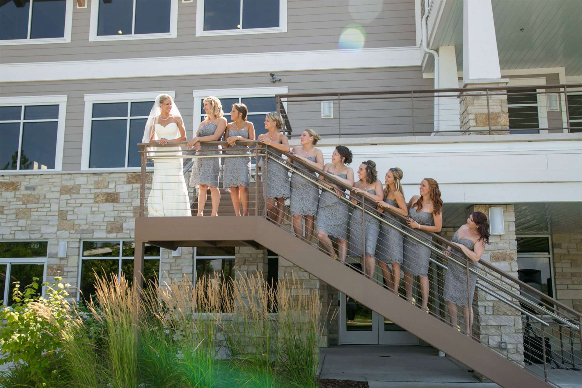 Bride and wedding party on stairs at the Oconomowoc Community Center