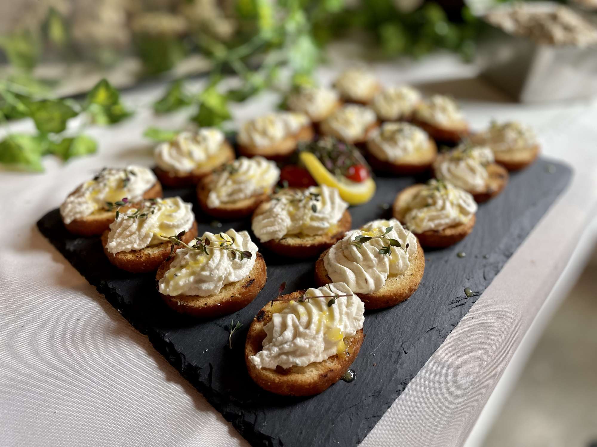 Crostini with whipped feta and honey are a perfect passed appetizer option offered by Saz's Catering