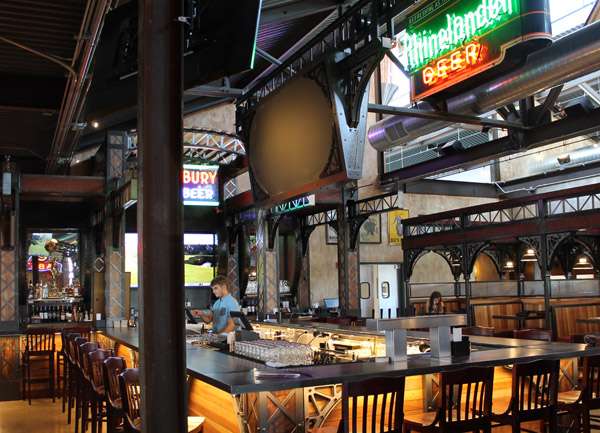 Long banquet tables with eucalyptus runners set the scene for Pearl and Cade’s romantic celebration filled with natural greenery and soft candlelight.