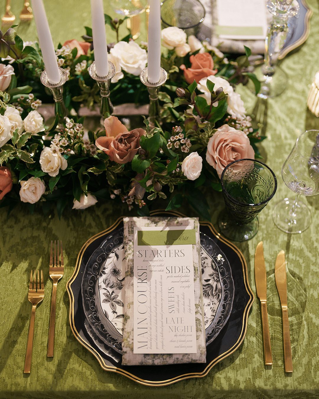 A luxurious wedding reception tablescape styled with floral centerpieces and a custom Noble Catering menu card.