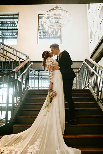 Bride and groom on the grand staircase at the Gage