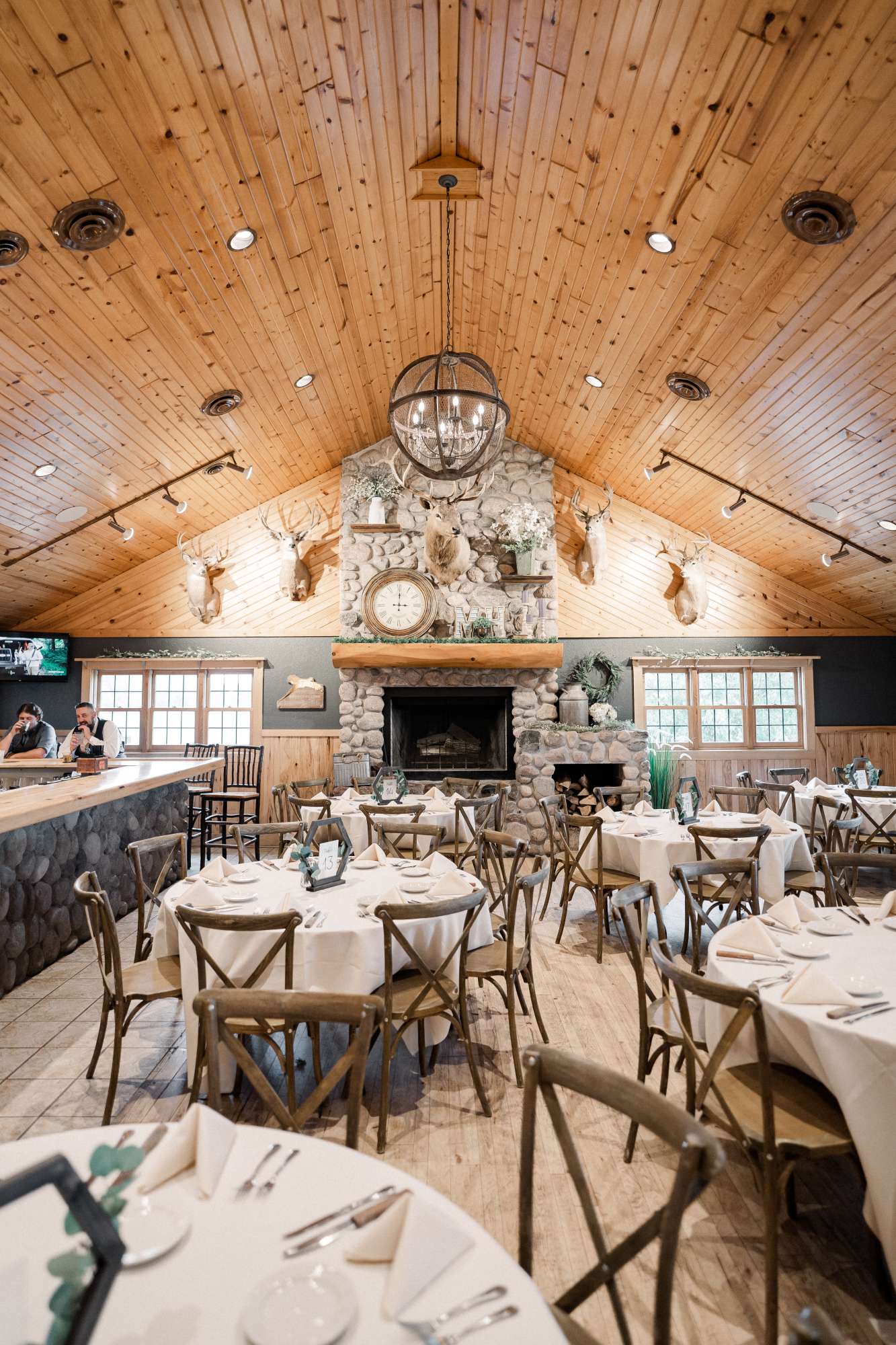 Another beautifully styled reception space at Milford Hills, featuring a grand stone fireplace and rustic décor with charming mounted wildlife.