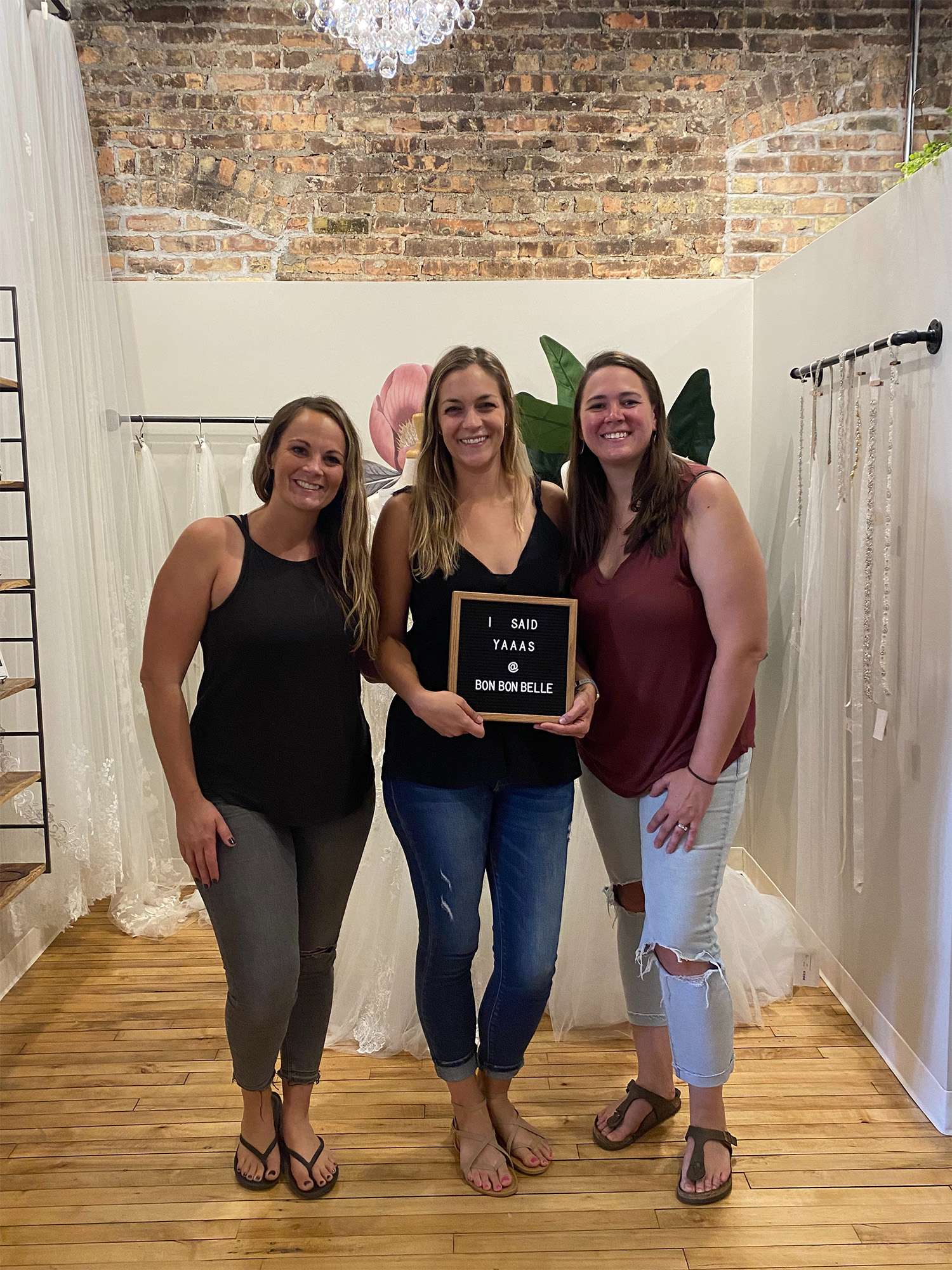 Future bride holding sign that reads