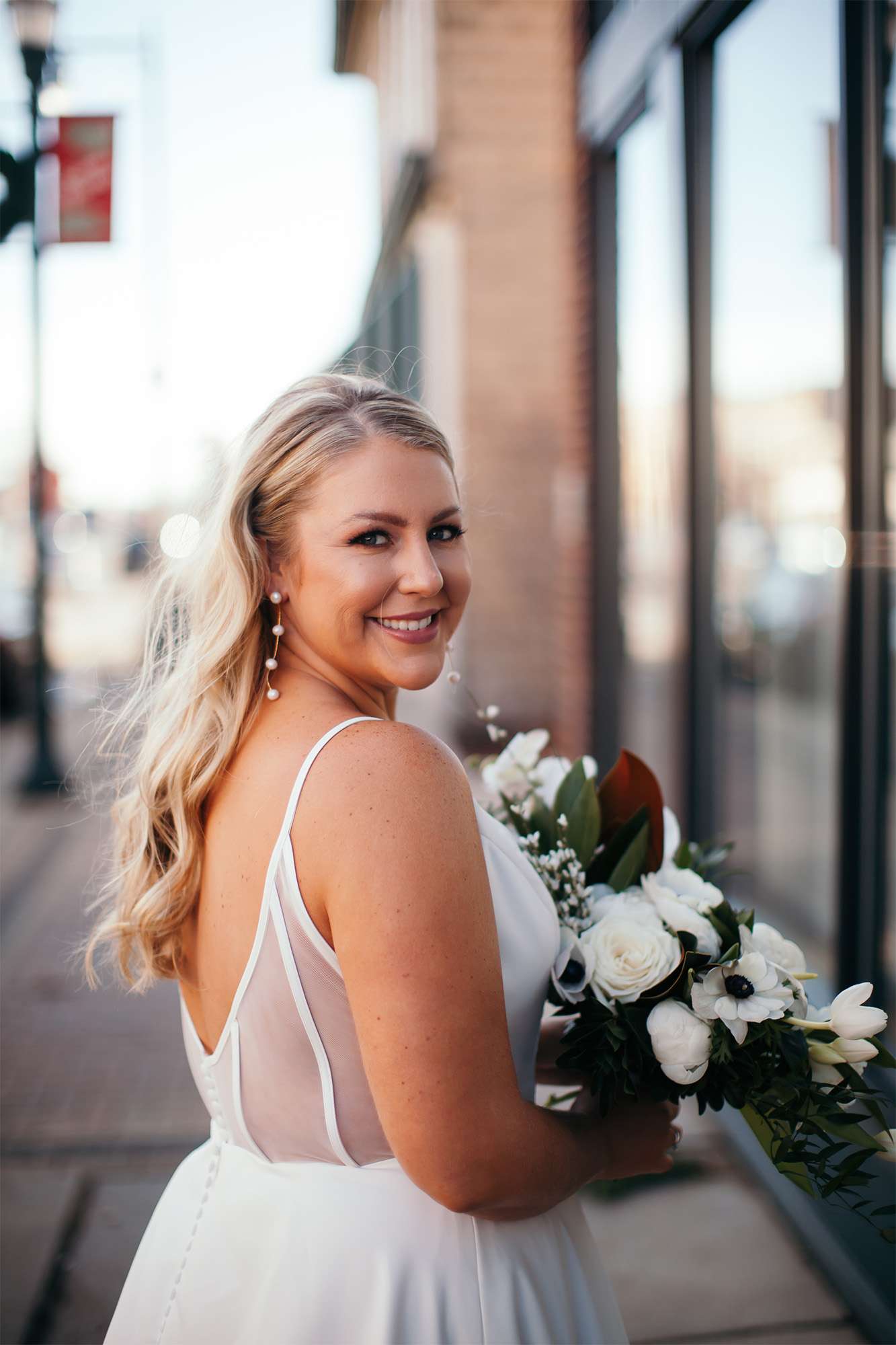 Bon Bon Belle Bride poses outside of the store in Burlington.