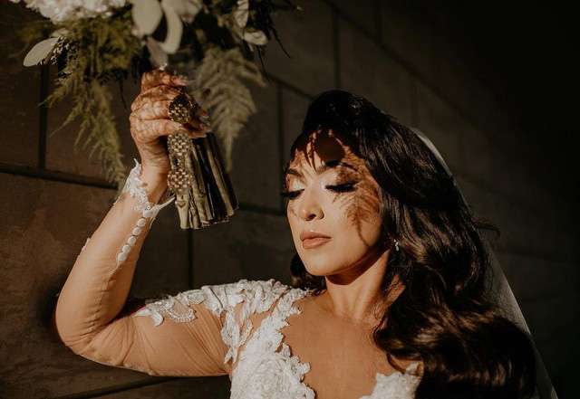 Beautiful bride holds up her bouquet.