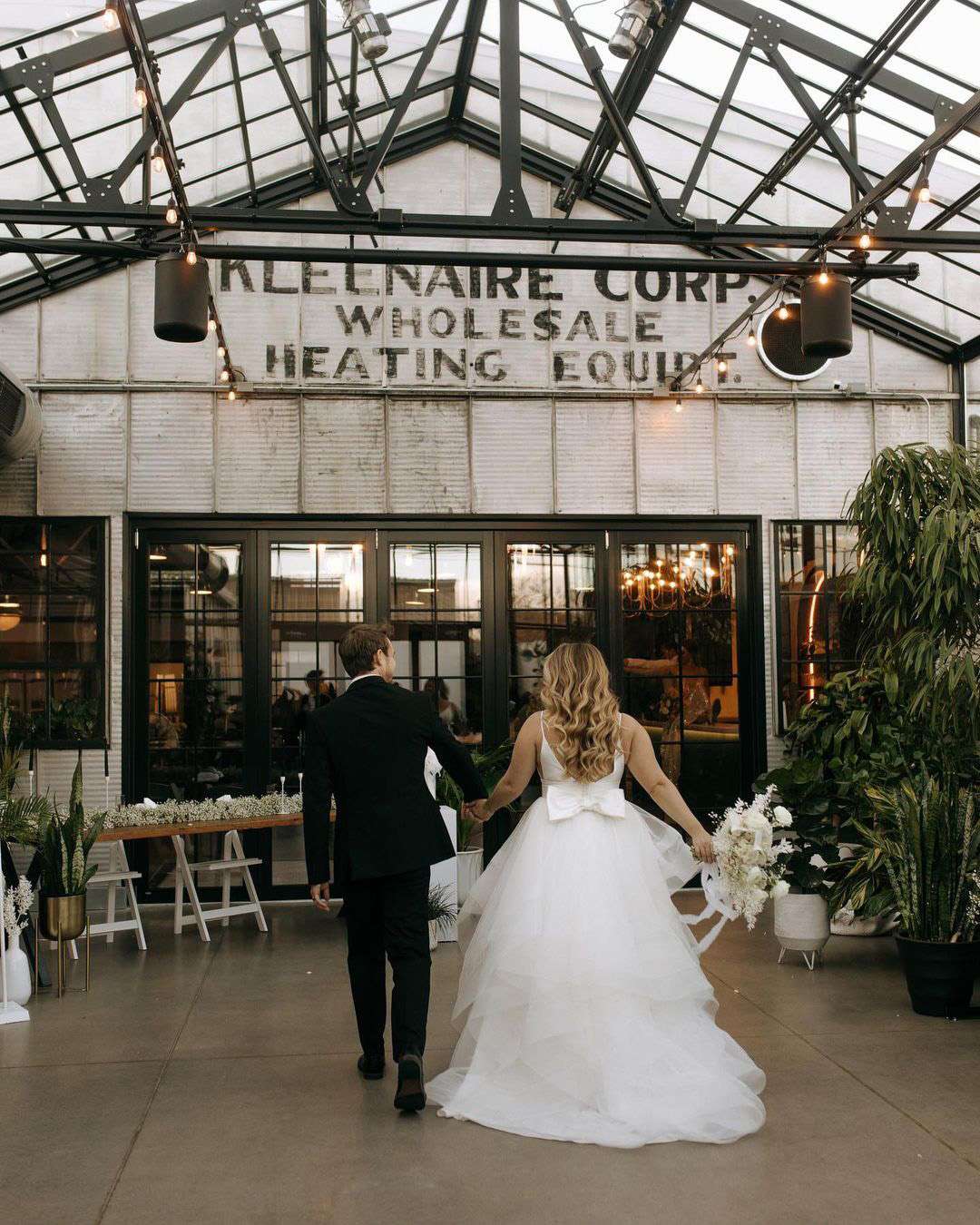 Bride and groom walk into venue.