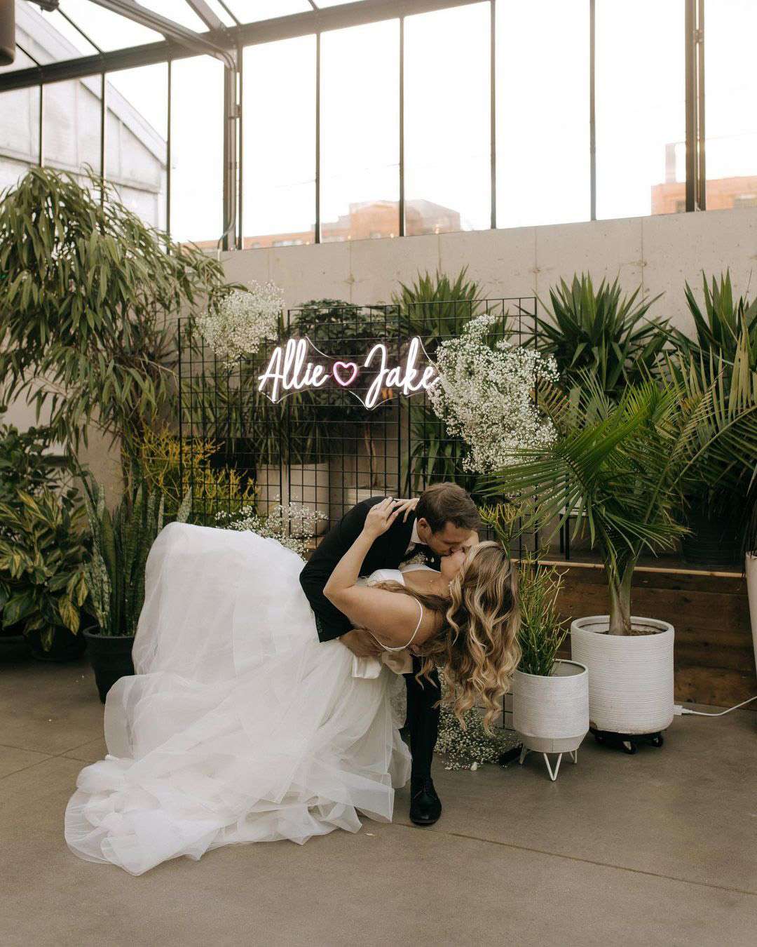 Groom dips bride wearing gown from Bon Bon Belle Bridal in Burlington, WI