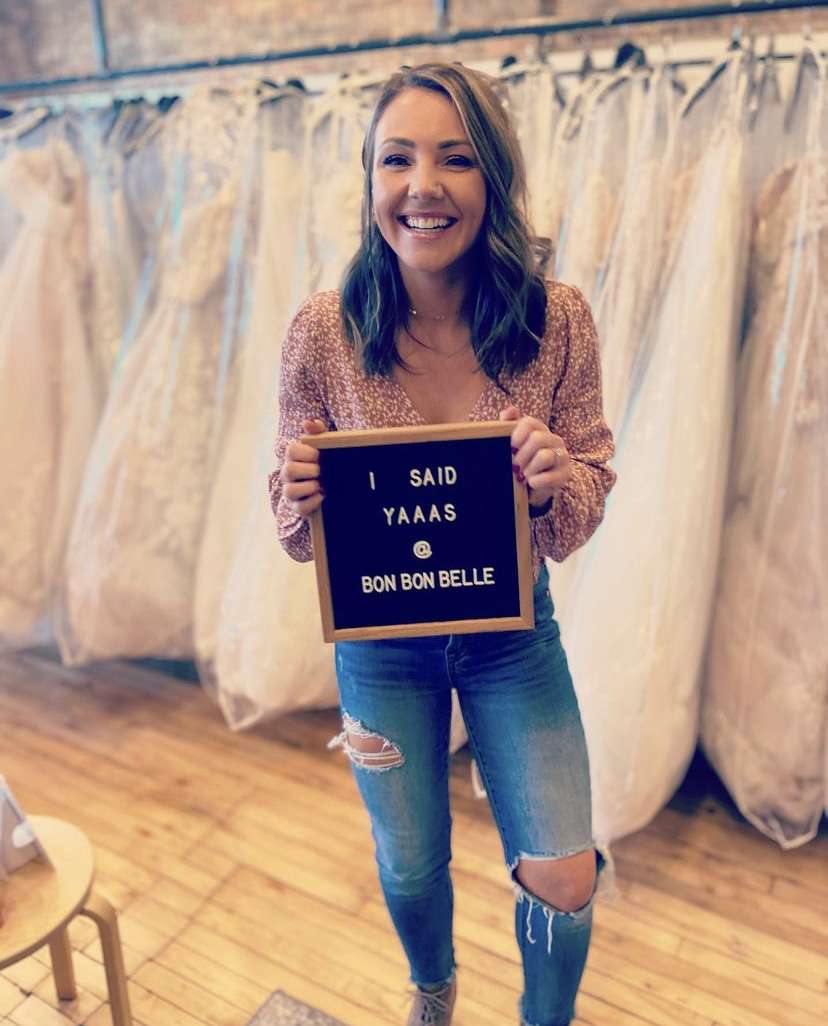 Future bride holding sign that reads