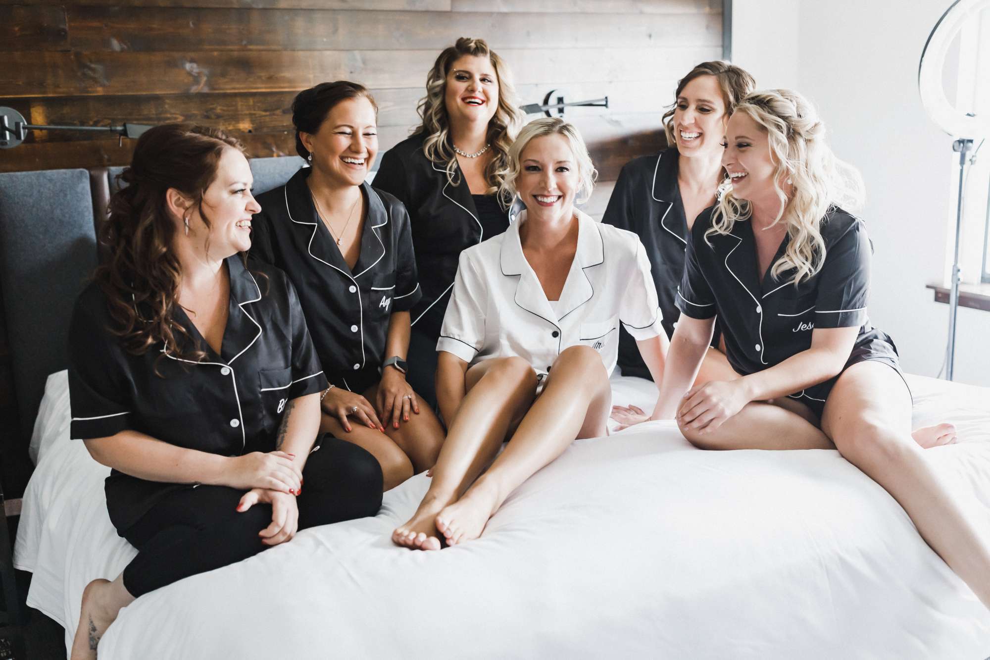 Bride and bridesmaids pose in suite at Ironworks Hotel Beloit
