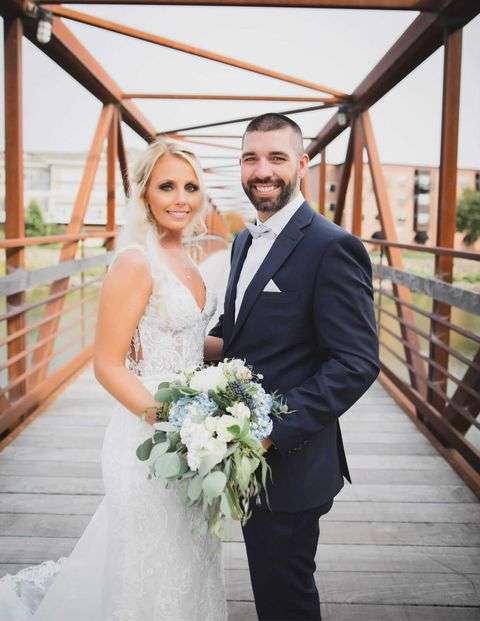Bride and groom pose on the Riverwalk Bridge in Beloit, WI