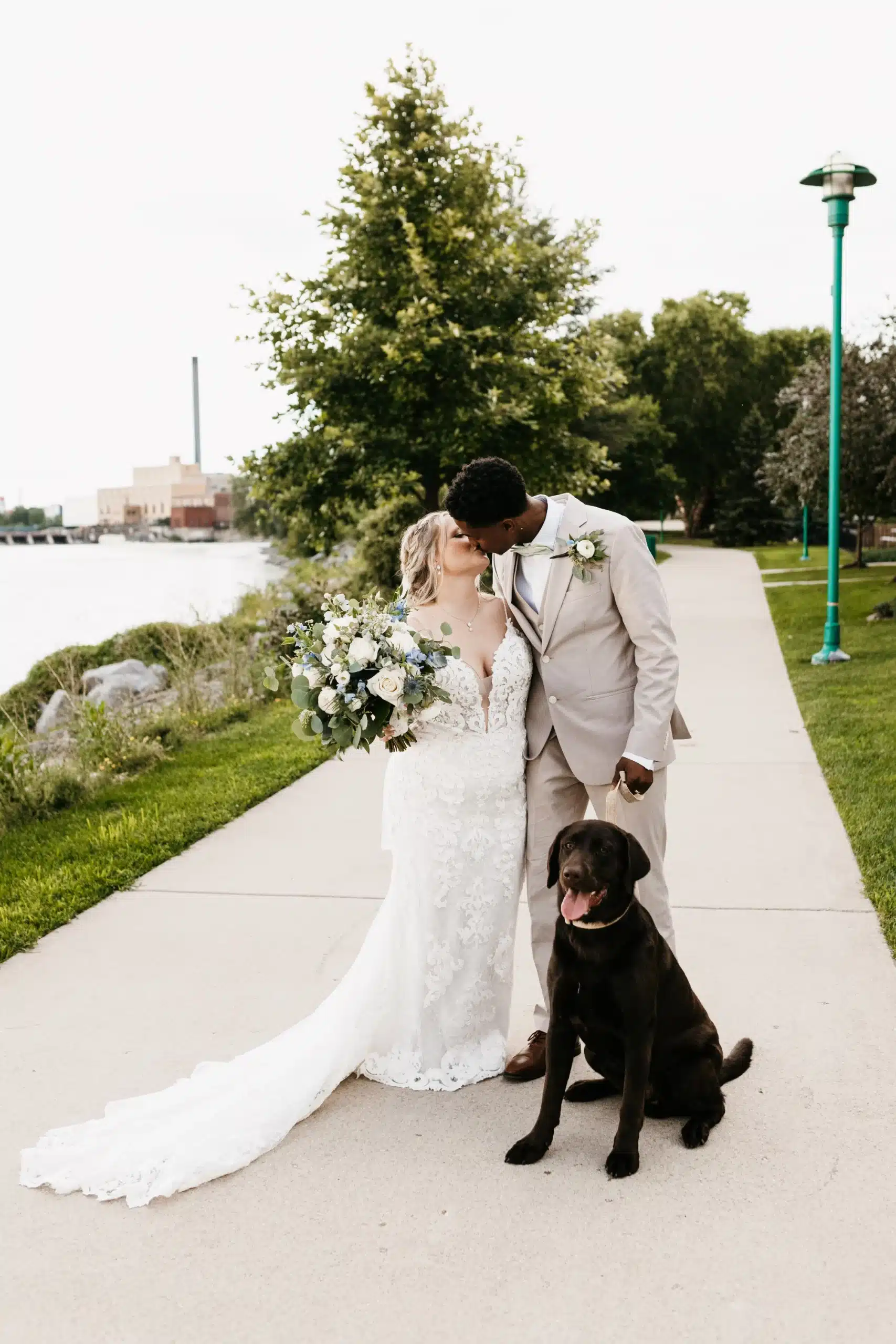 Bride and groom kissing on the grounds of Ironworks Hotel Beloit.