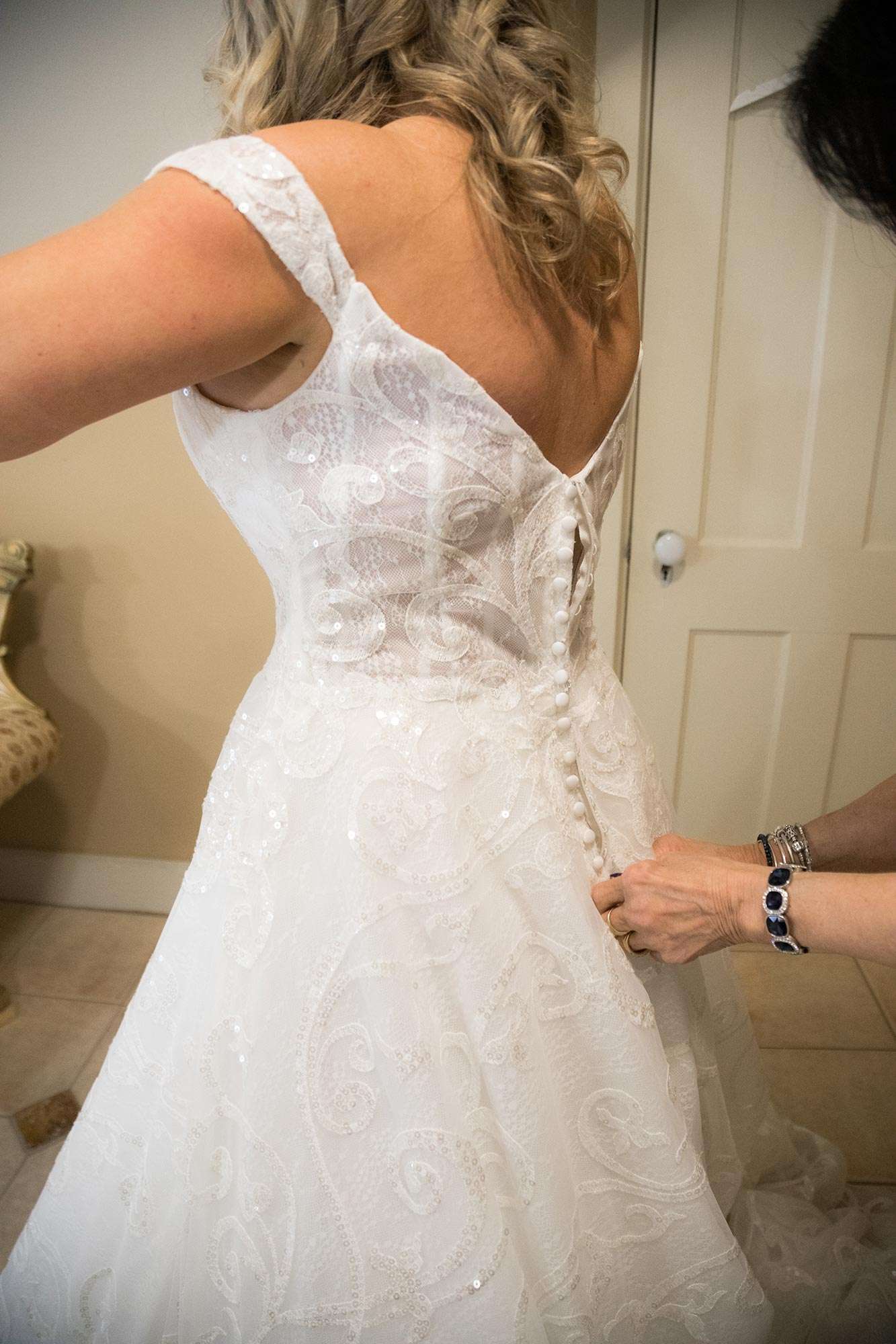 Karrie's dress from Amelishan Bridal gets fastened in the back