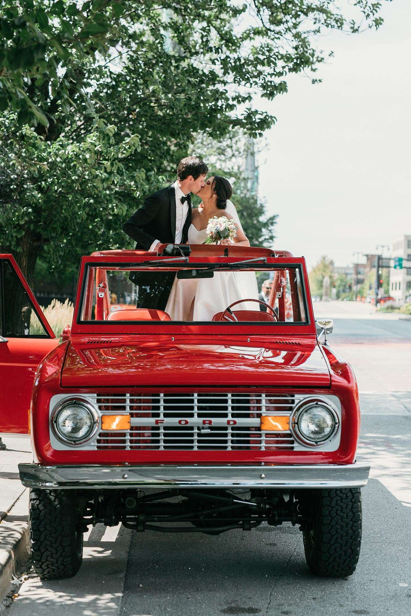 bride and groom kissing in red ford truck bride and groom kissing in red ford truck