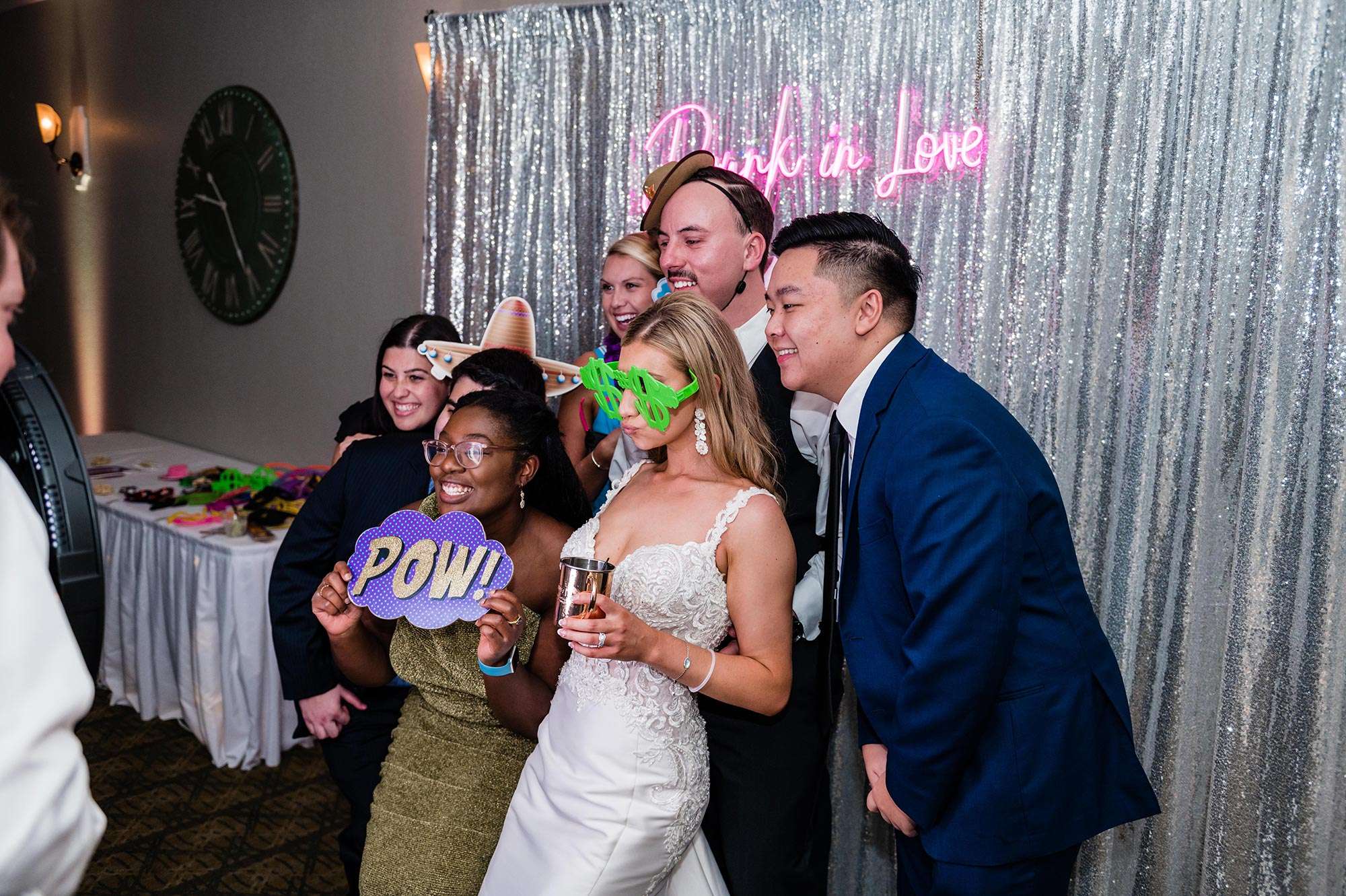 bride and groom with guests using photo props Complete Weddings + Events | Photo Booth