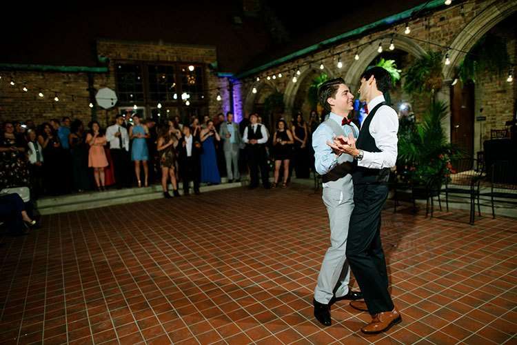 A heartwarming moment of newlyweds sharing a dance under the evening lights in Captain’s Courtyard at Best Place at Historic Pabst Brewery.