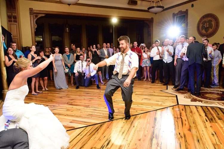 Guests joyfully dancing to vibrant lights and music in the lively Blue Ribbon Hall at Best Place at Historic Pabst Brewery.
