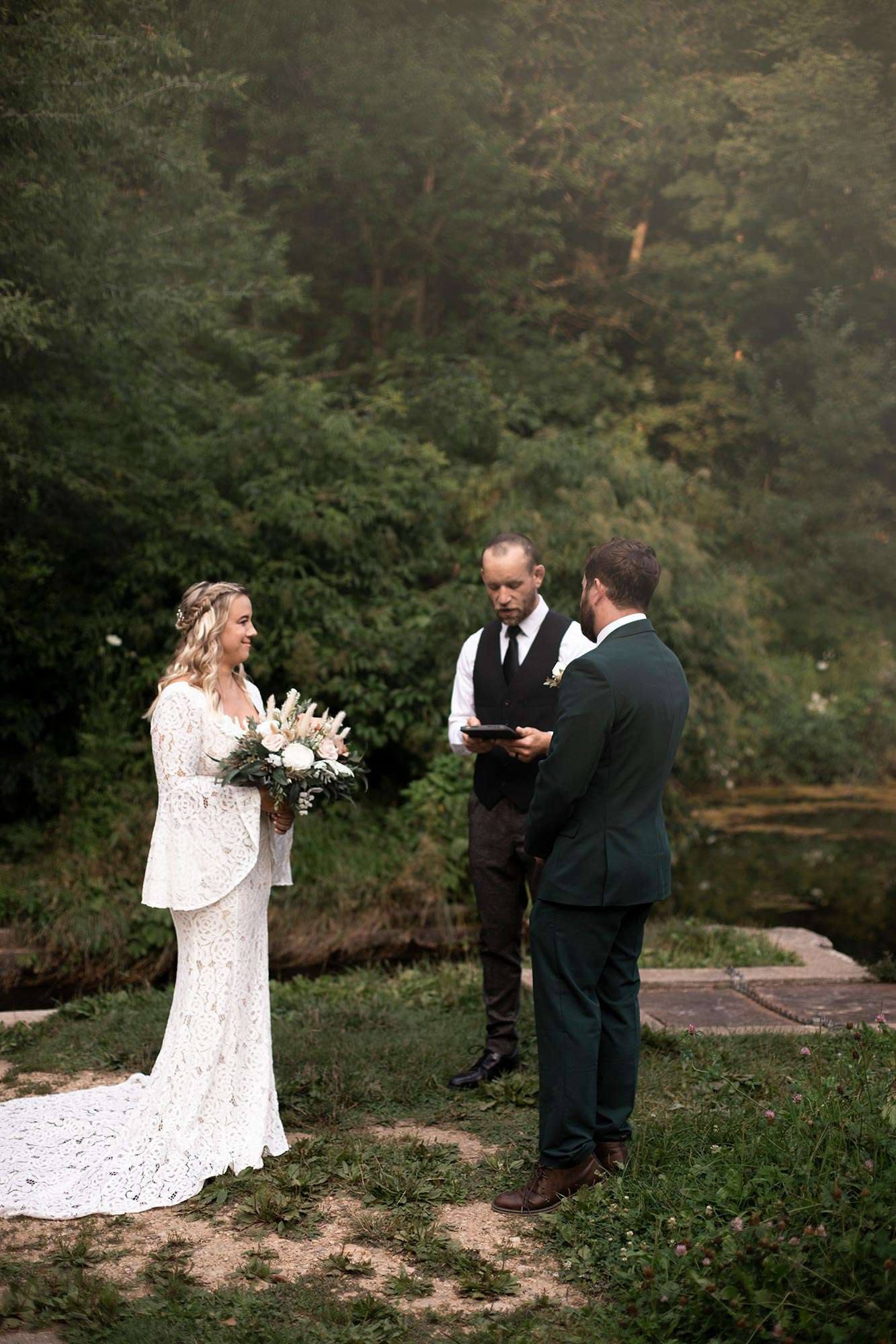 couple looking at officiant during ceremony couple looking at officiant during ceremony