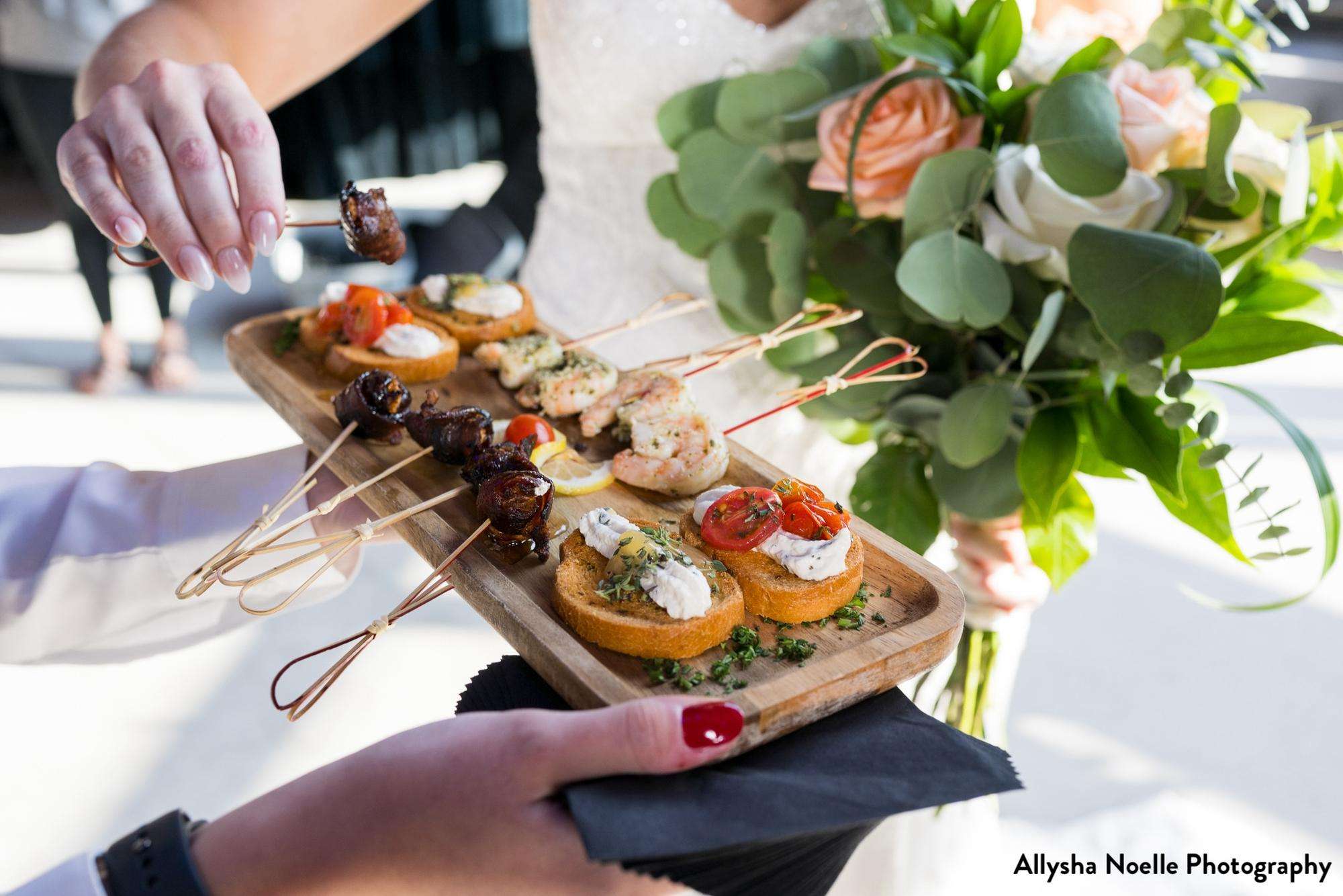 A close-up of a beautifully presented appetizer tray with a mix of bite-sized treats, served at a wedding at Jan Serr Studio.