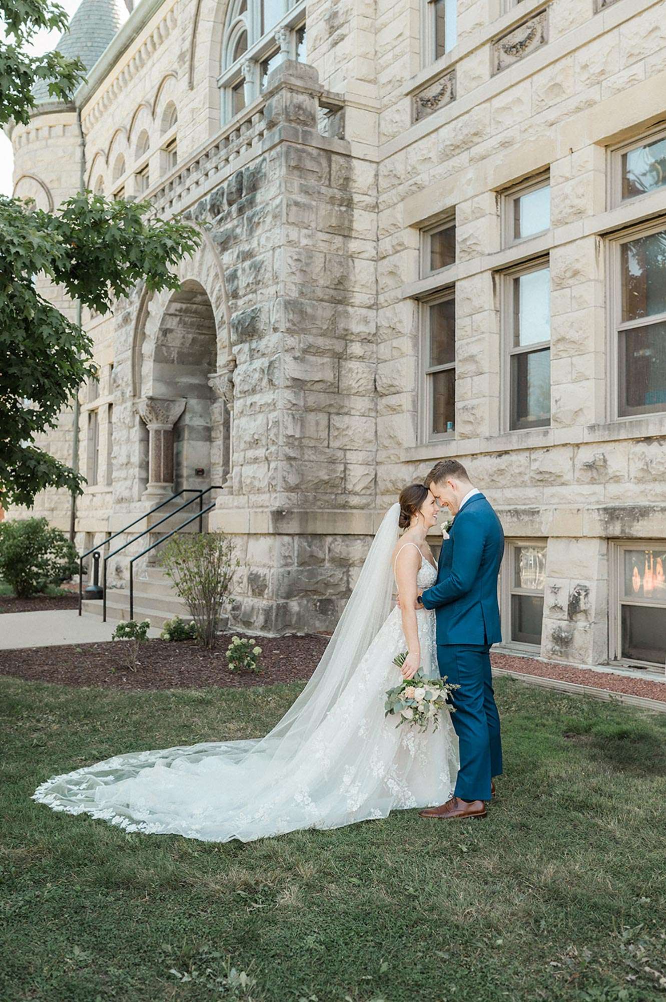 Couple with foreheads together near stairs at Courthouse