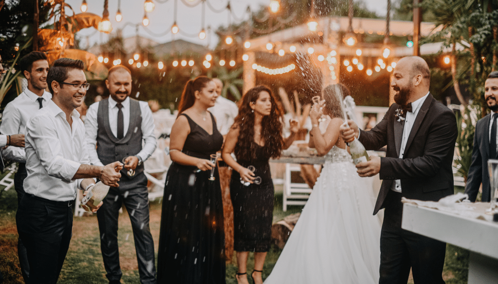 Bride and groom having a champagne toast at outdoor wedding reception.