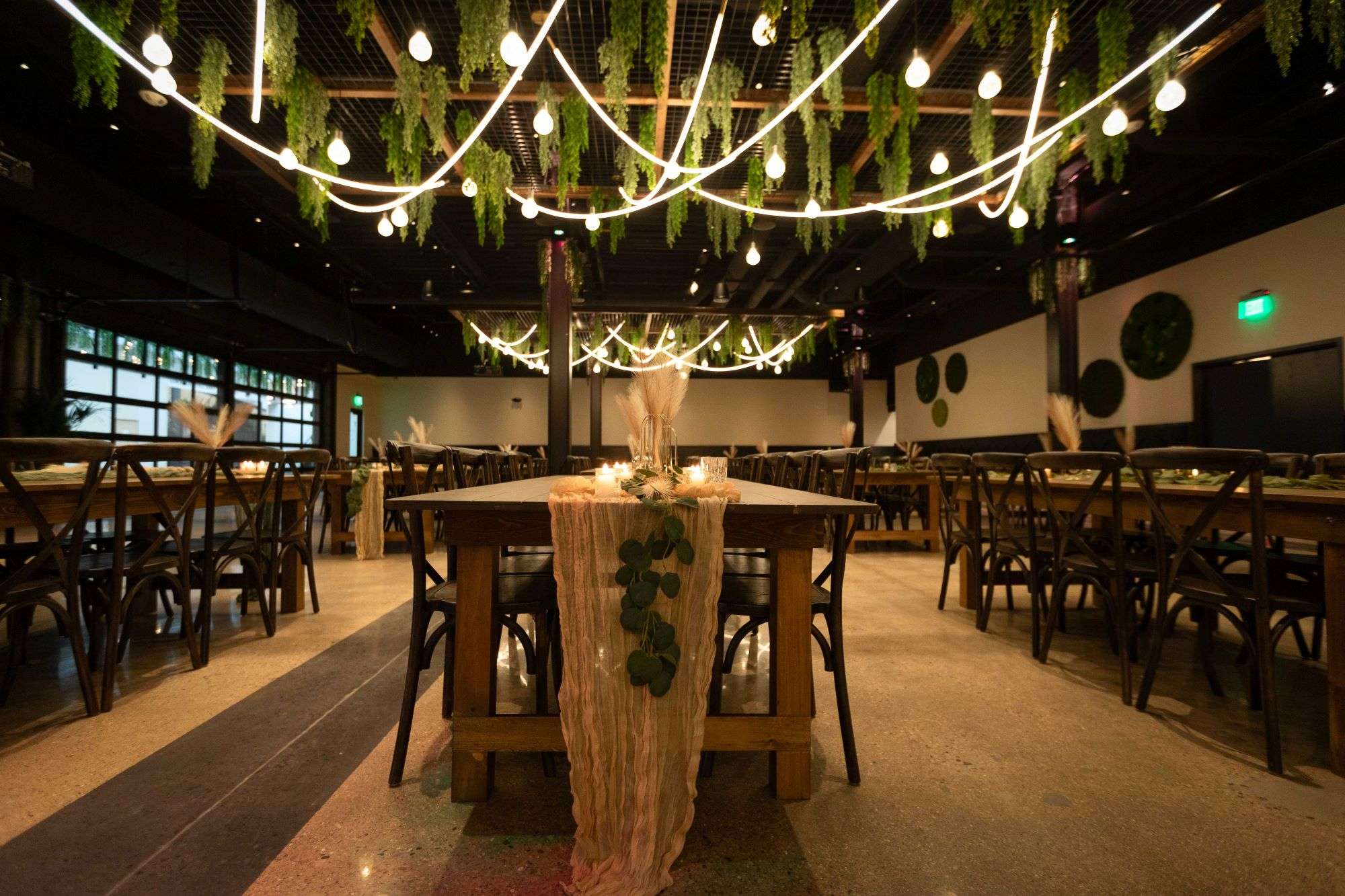 rustic table setting, green foliage, bulb lighting and more offered at Venue 3