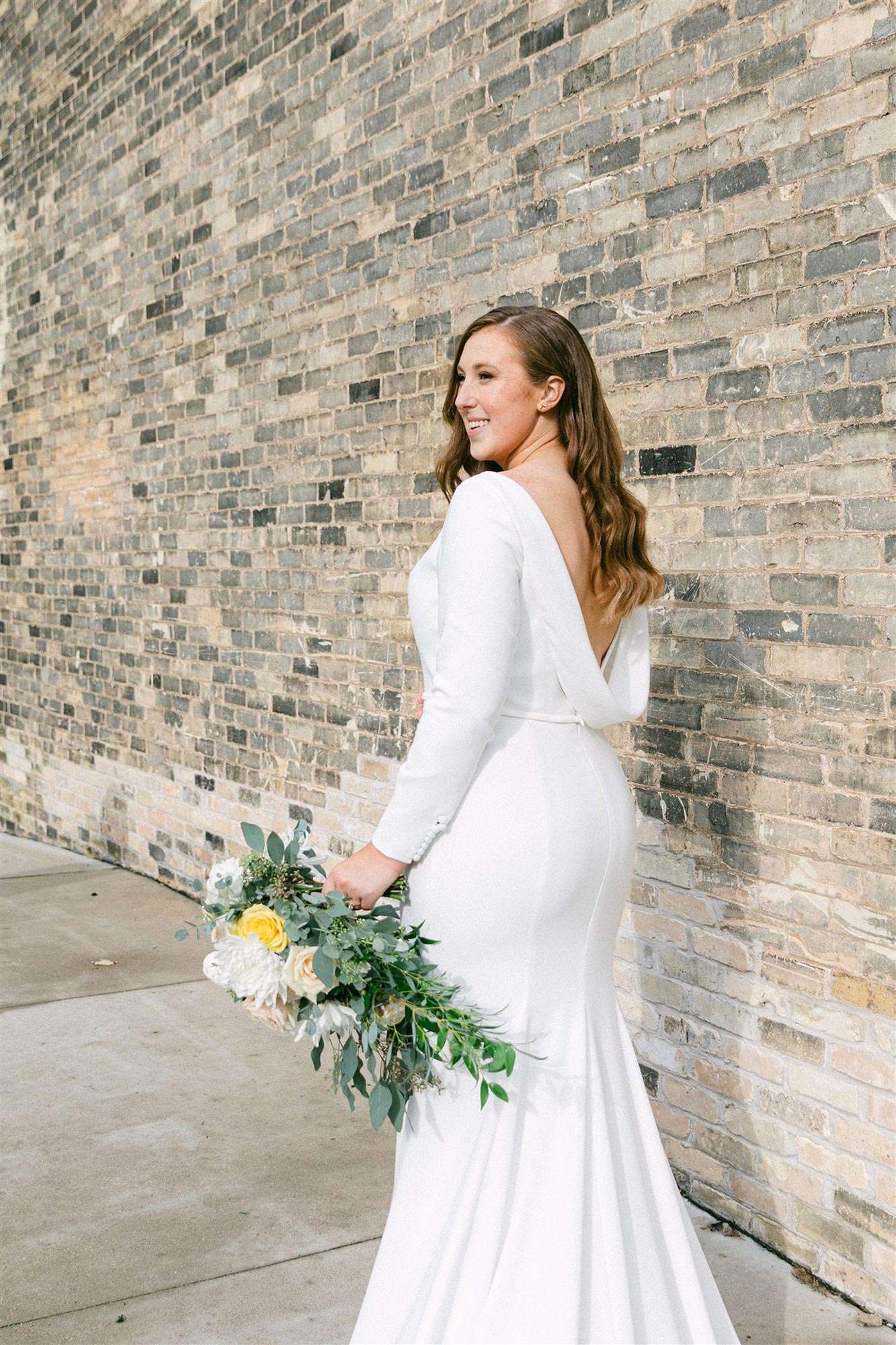 back of bride's fitted dress from White Dress Bridal Boutique with open/draped back