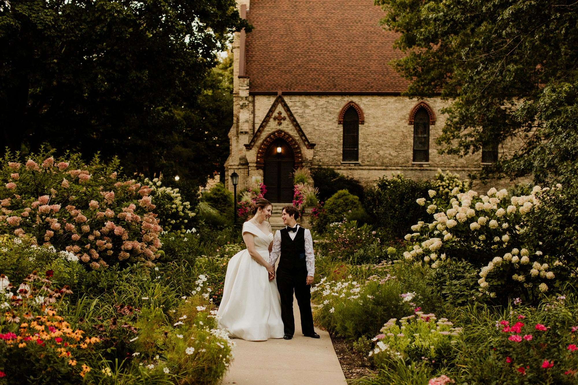couple looking at each other surrounded by colorful gardens a