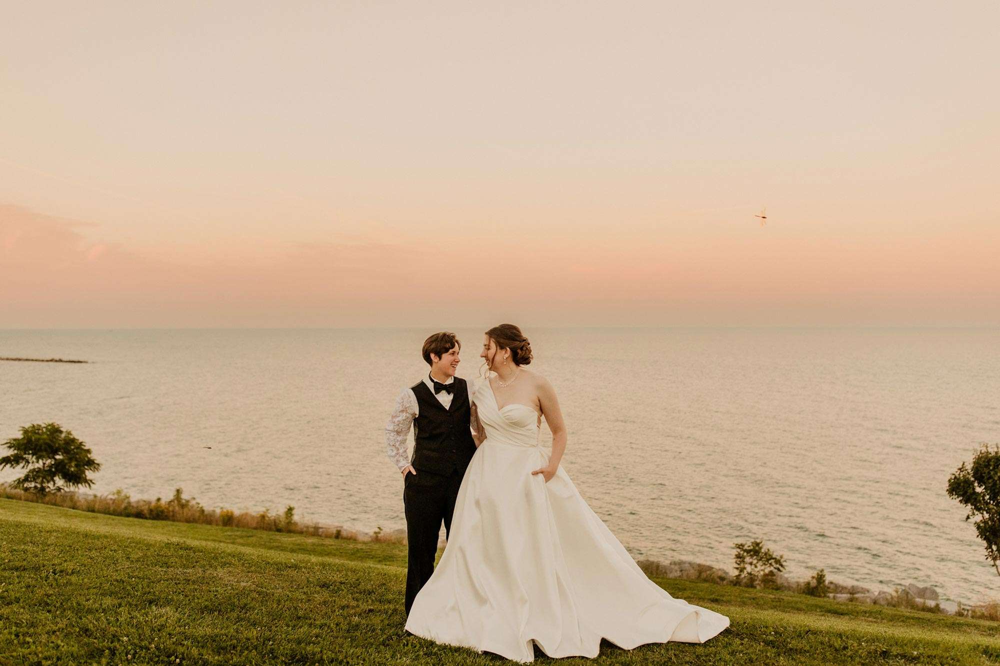 coupe standing at shoreline with beautiful skies at sundown