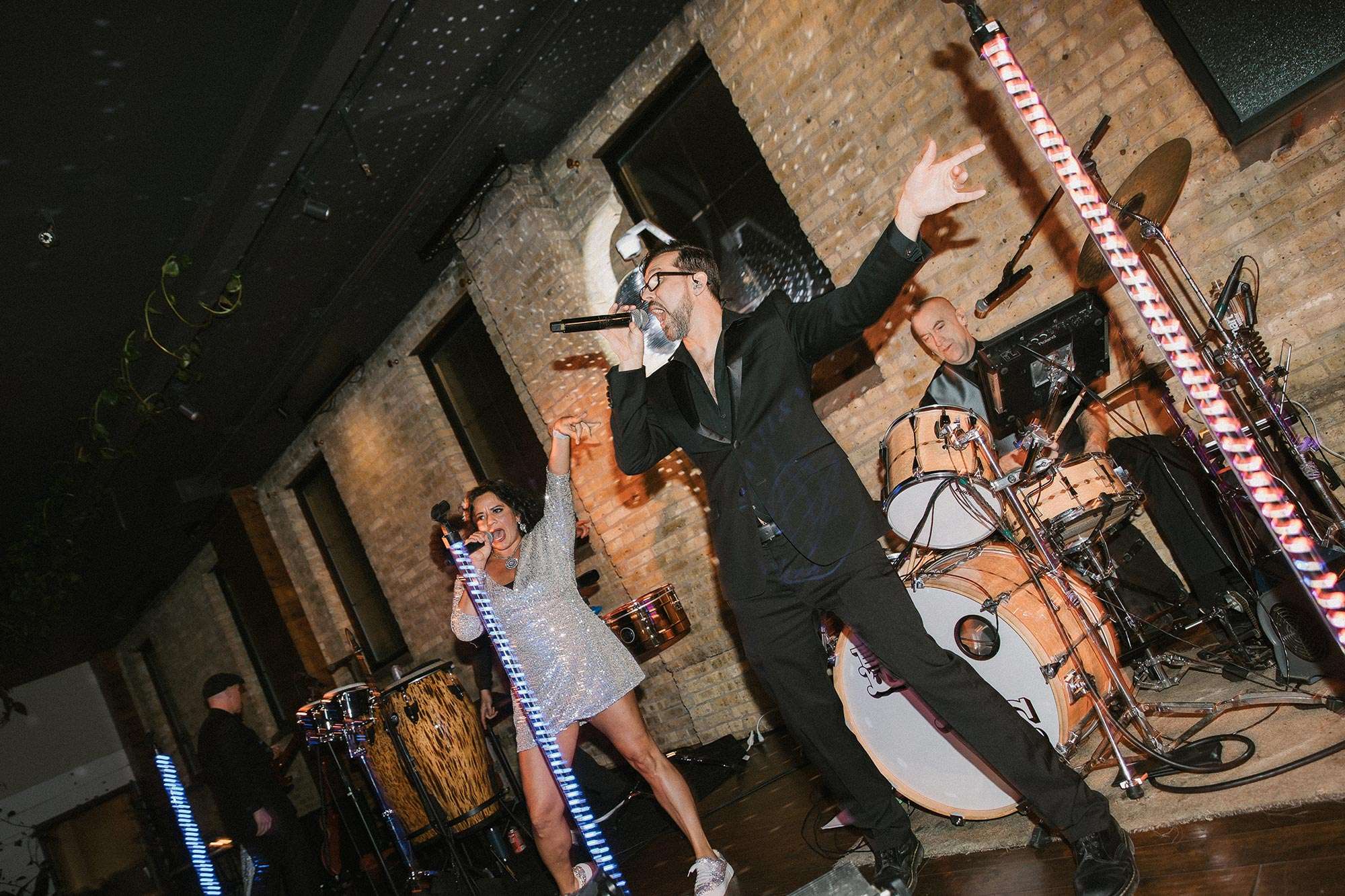 Libido Funk Circus band members singing on stage Libido Funk Circus band members singing on stage