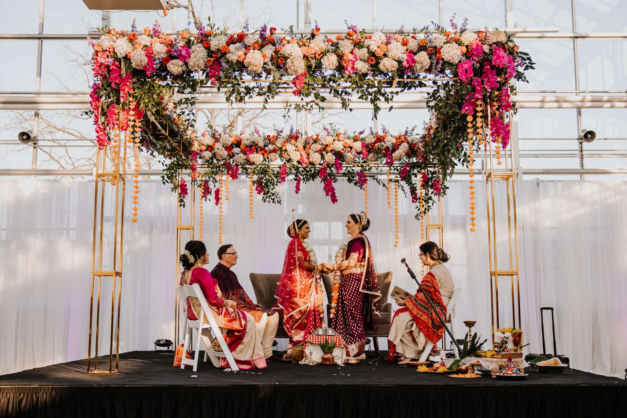 Beautiful reds and blushes for an Indian wedding ceremony created by Reflections of You