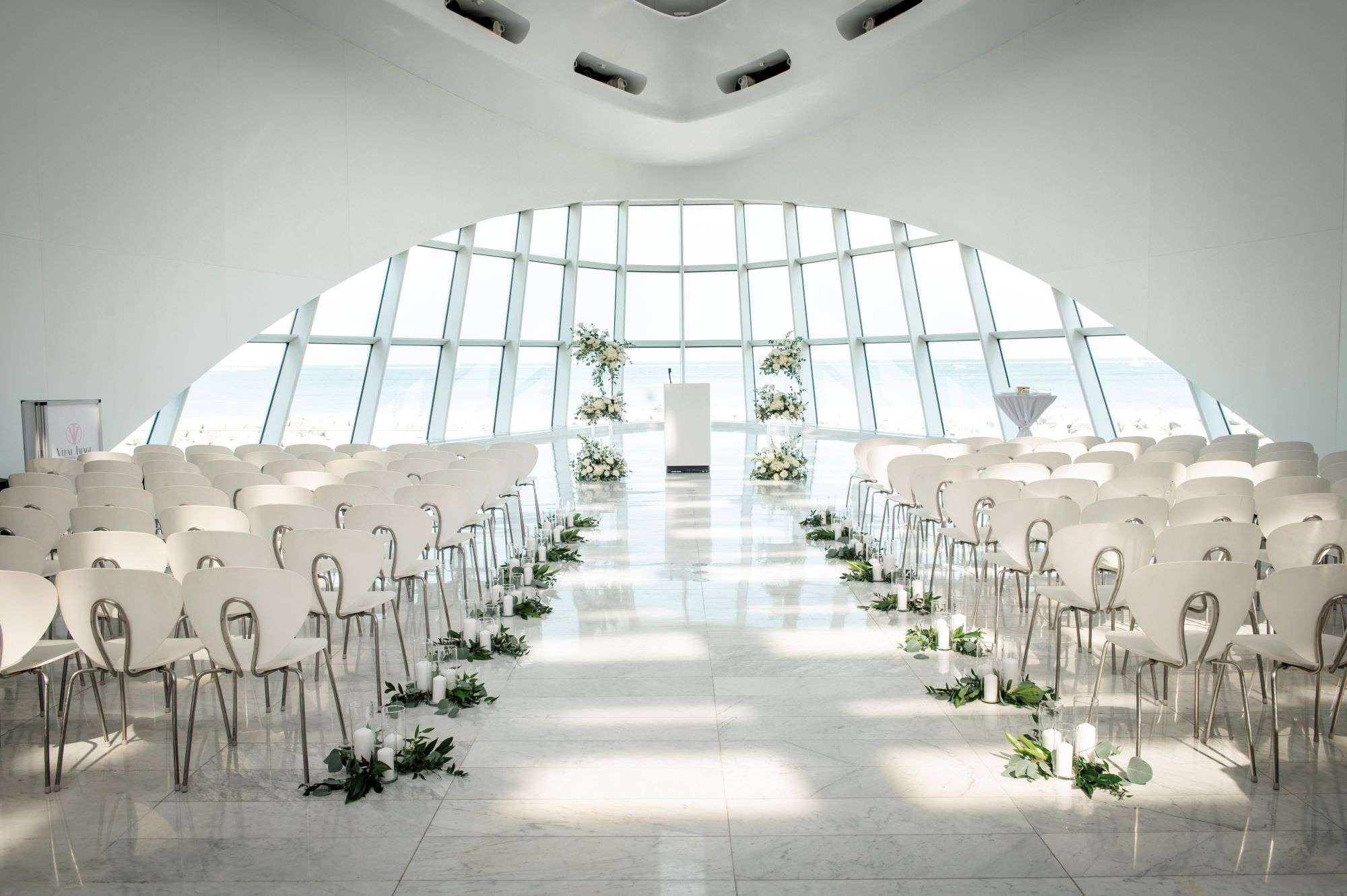 Milwaukee Art Museum with white and greenery ceremony floral by Reflections of You