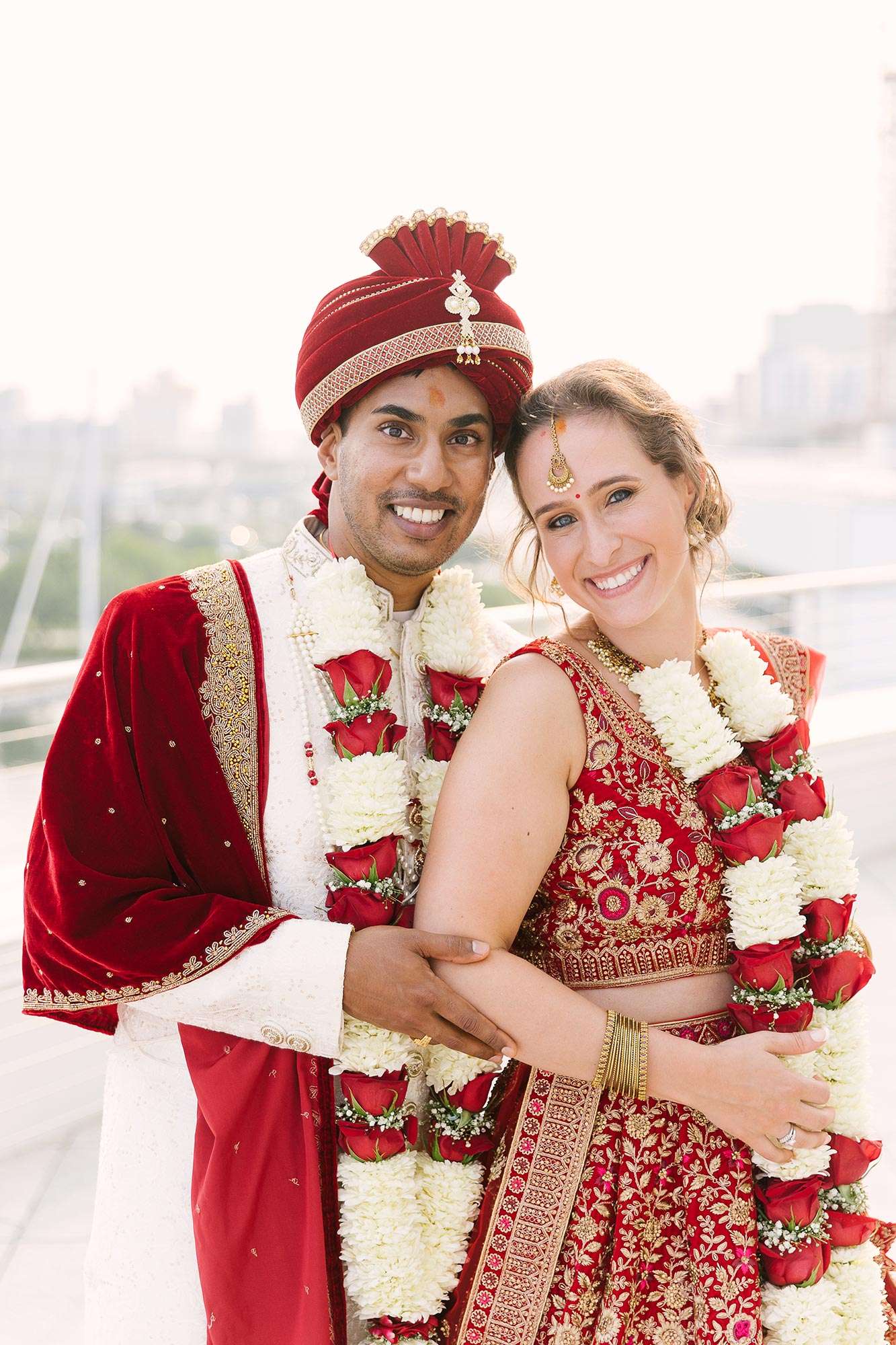 couple posing outdoors in Indian attire with background blurred – bride’s hair & makeup by The Knick Salon couple posing outdoors in Indian attire with background blurred - bride's hair & makeup by The Knick Salon