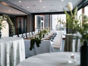 Simple and modern white, black, and greenery add soft touches to the modern Northern Lights Event Venue