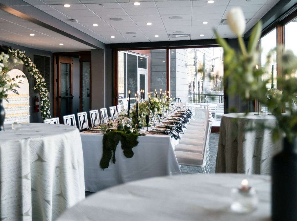 Simple and modern white, black, and greenery add soft touches to the modern Northern Lights Event Venue
