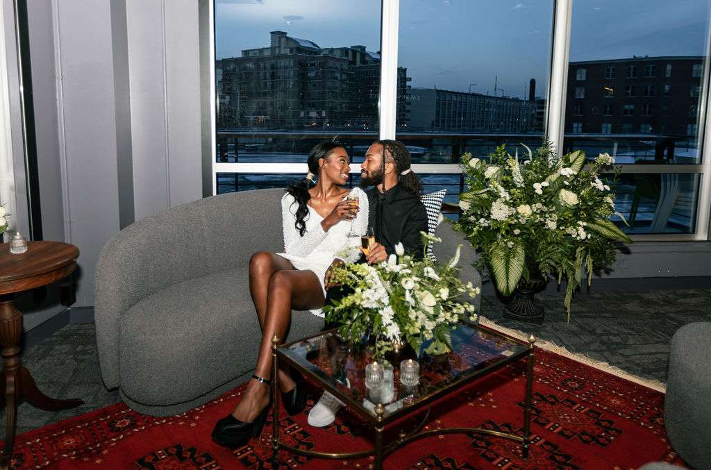 Bride and groom pose in the modern lounge at Northern Lights Event Venue