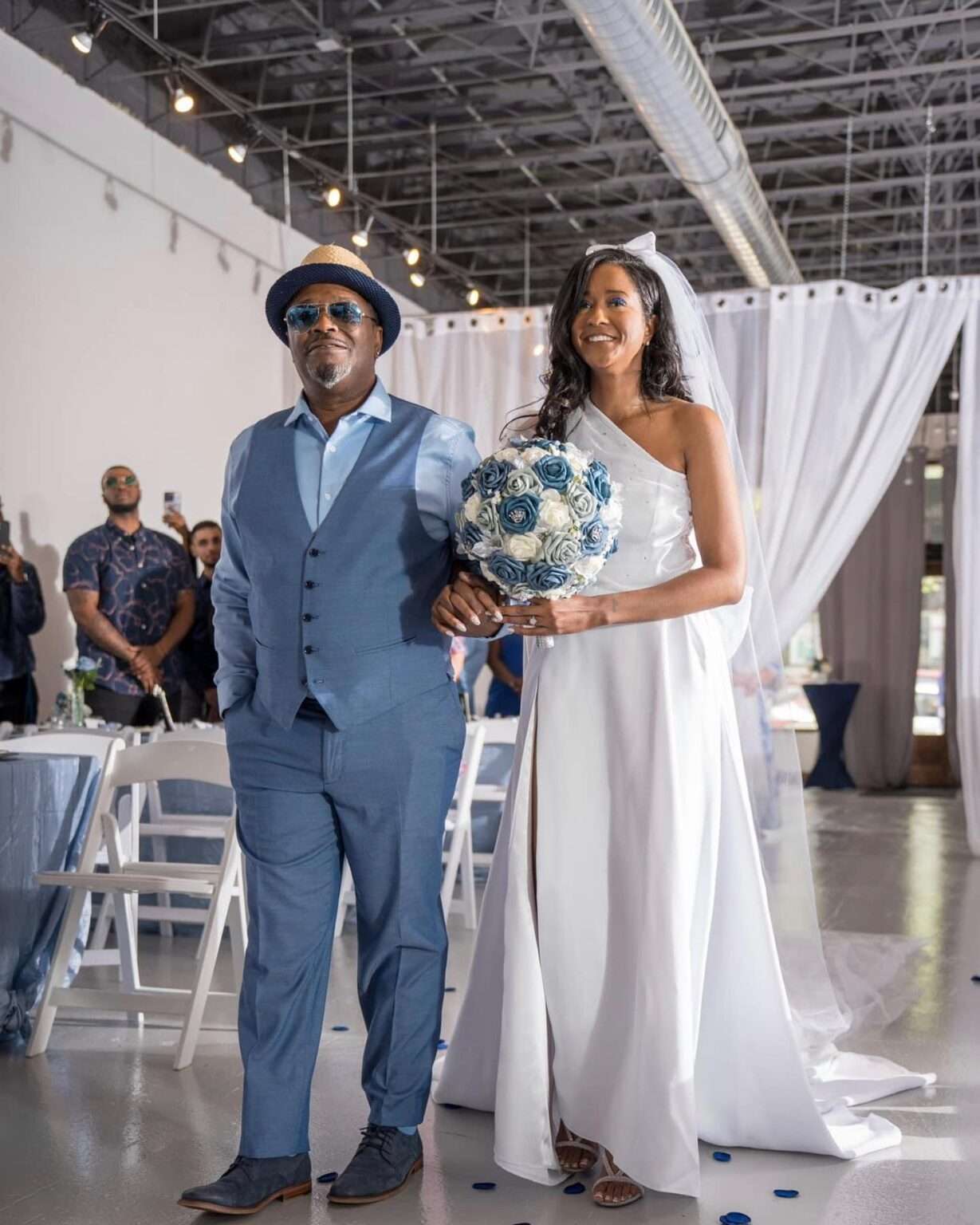 Bride and her escort walking down the aisle at The Mitch, highlighting the venue’s spacious, well-lit ceremony setup.