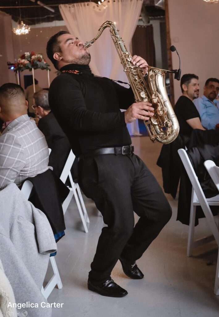 A saxophonist performing live during an event at The Mitch, highlighting the venue’s entertainment-friendly design.