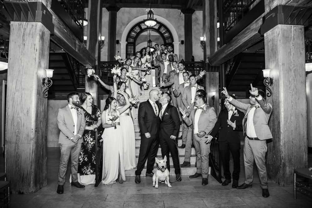 OlsenLeggettWedding_8172021_Portraits006 lively wedding party gathers on the impressive staircase of The Rivulet, making for an unforgettable group photo in this iconic venue.
